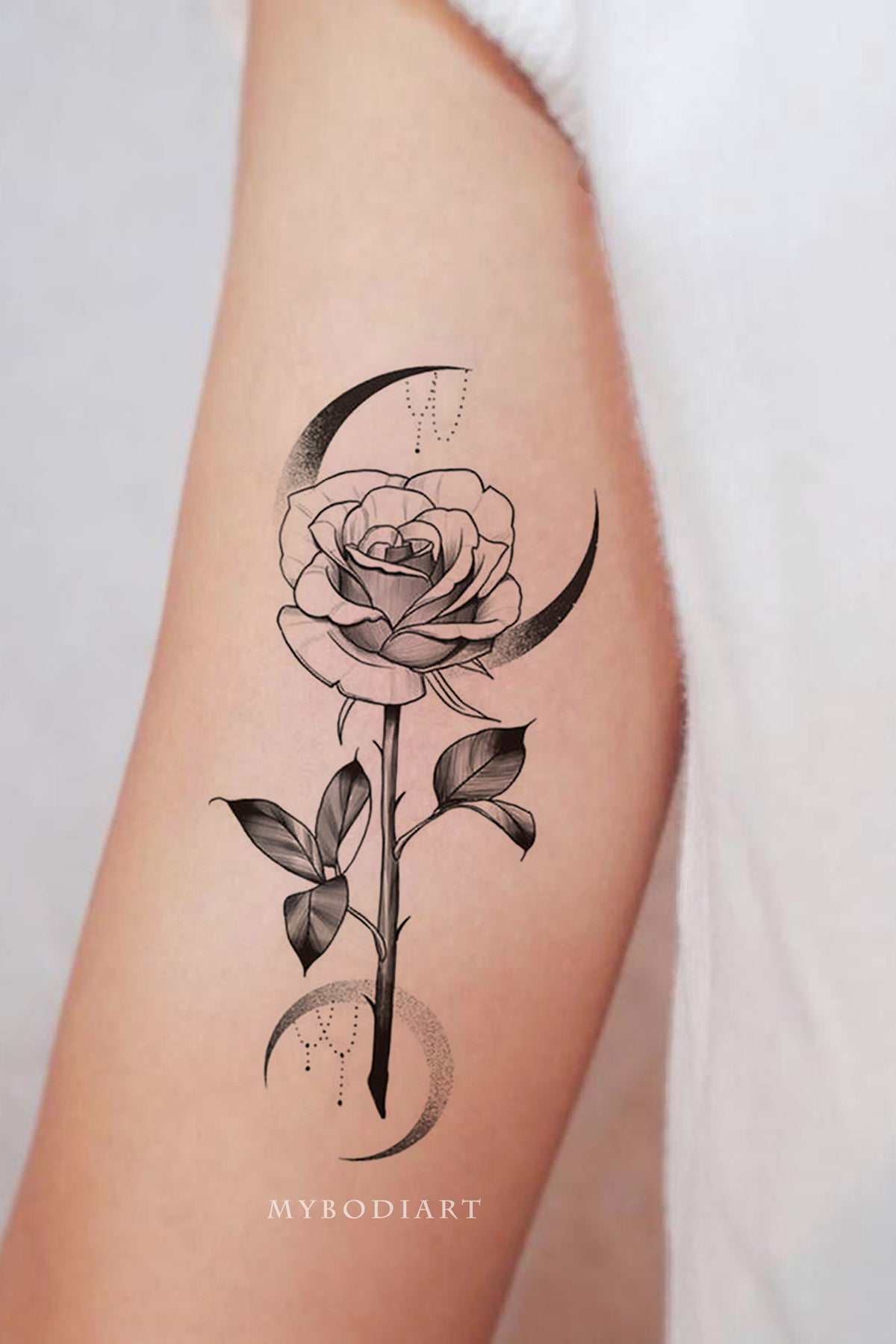 Single needle rose tattoo on the left inner forearm
