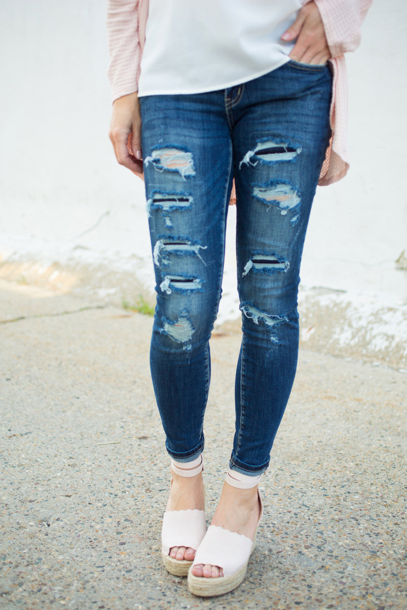 distressed dark blue jeans