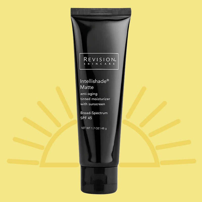 A tube of Revision Intellishade Matte SPF 45 against a yellow background with a sun illustration.
