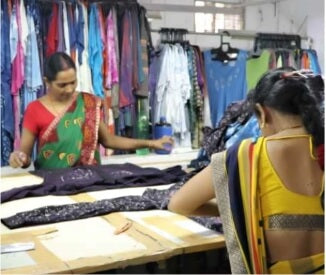 Artisan women work on creating garments