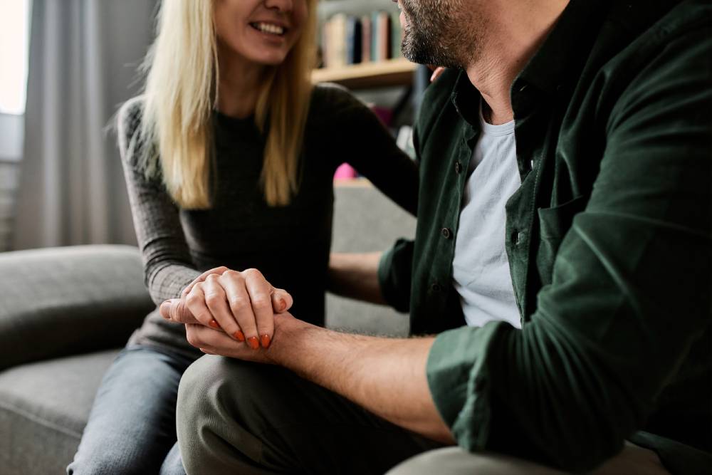 Supportive partners hold hands