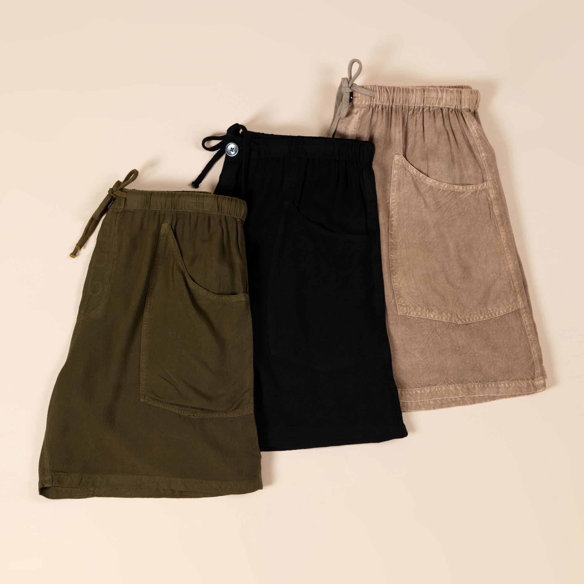Three pair of solid-colored earth tone shorts