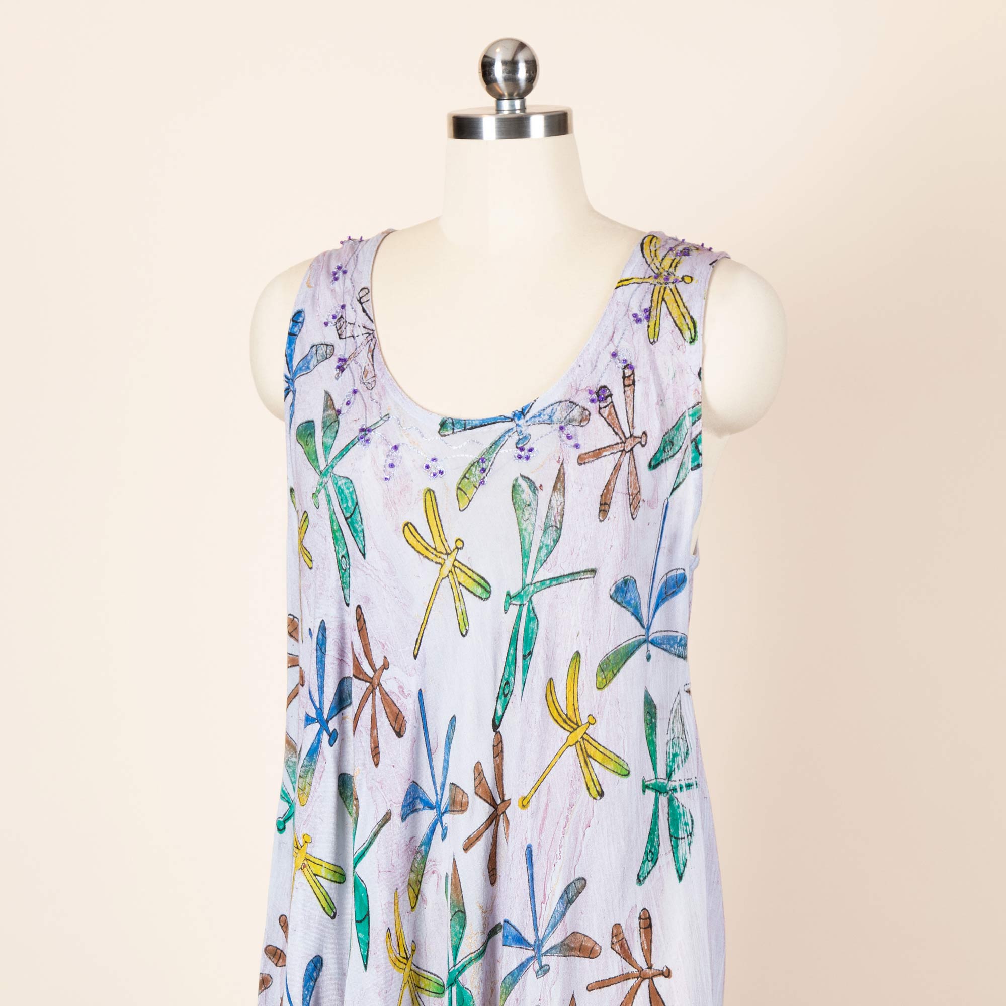 A dress adorned with a dragonfly print, created by hand using artisanal wooden stamps