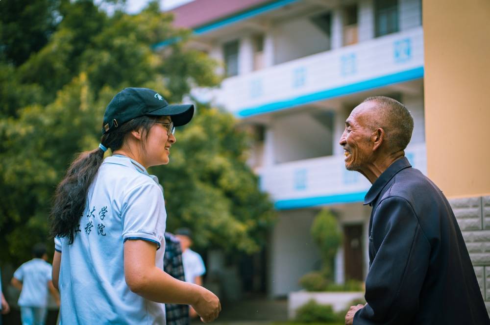 Volunteer smiles at community member