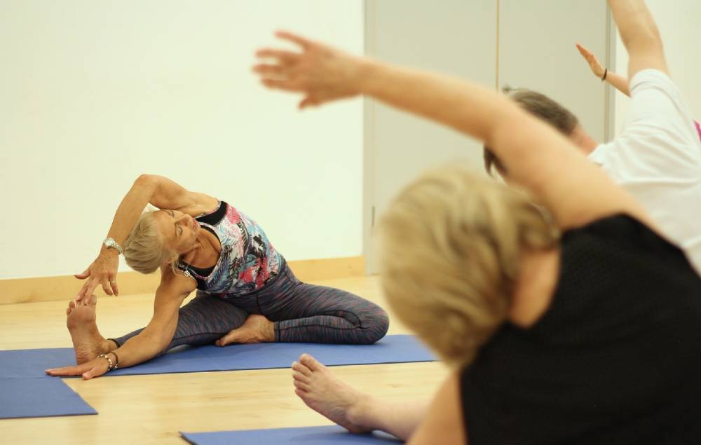 Older women stretch in yoga class