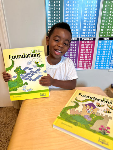 boy holding foundations workbook