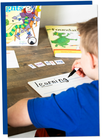 Young student practicing handwriting to reinforce sound-letter correspondences