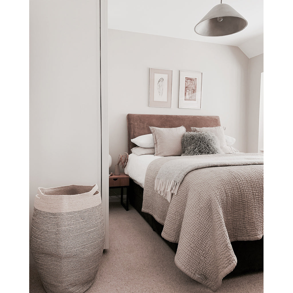 Bedroom interior styling with muted tones and woven basket
