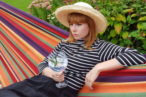 Woman in amazonas hammock with gin and tonic