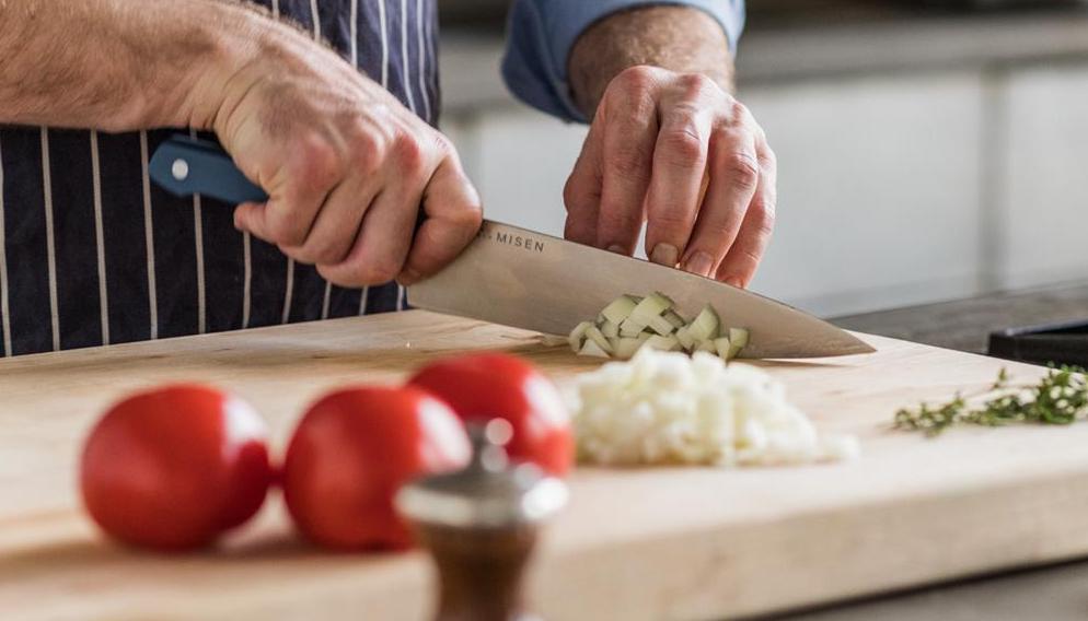 Chef knives: A man slices vegetables with a chef knife