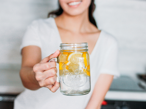 woman drinking lemon water