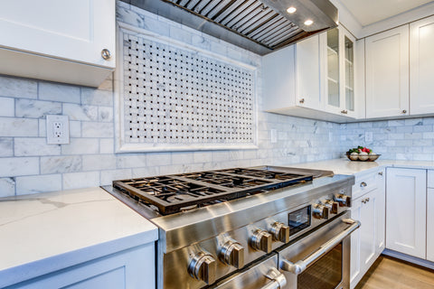 Carrara Marble Subway Tile and Basketweave Tile Feature Over Stove
