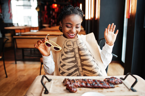 Girl eating barbecued ribs