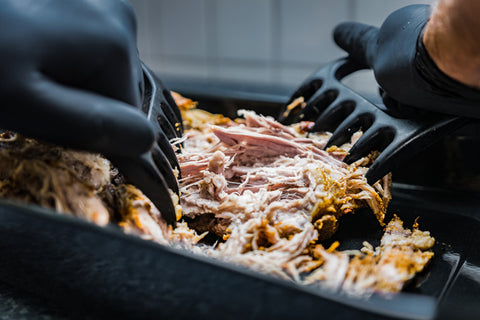 Pulled pork hooks while cutting meat