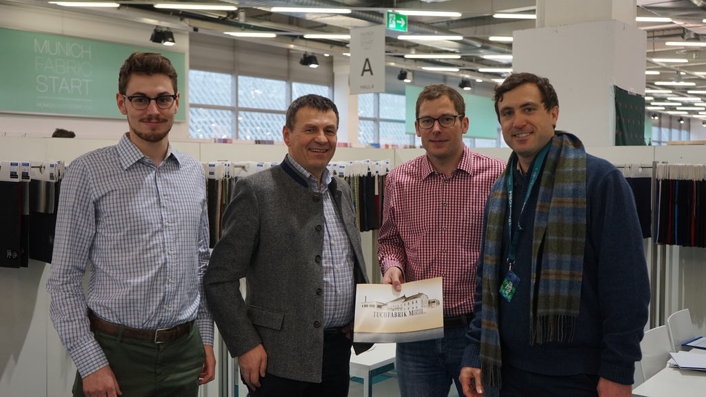 Robert W. Stolz standing with Julius and Maximilian Mehler from Gebrüder Mehler at the Munich Fabric Start textile show