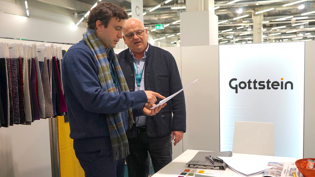 Robert W. Stolz looking at a fabric sample with Robert Scheuch from Gottstein in Munich