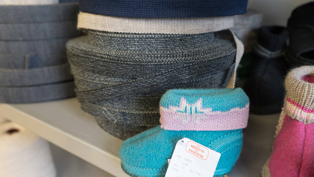 a wool house slipper for a child on a shelf