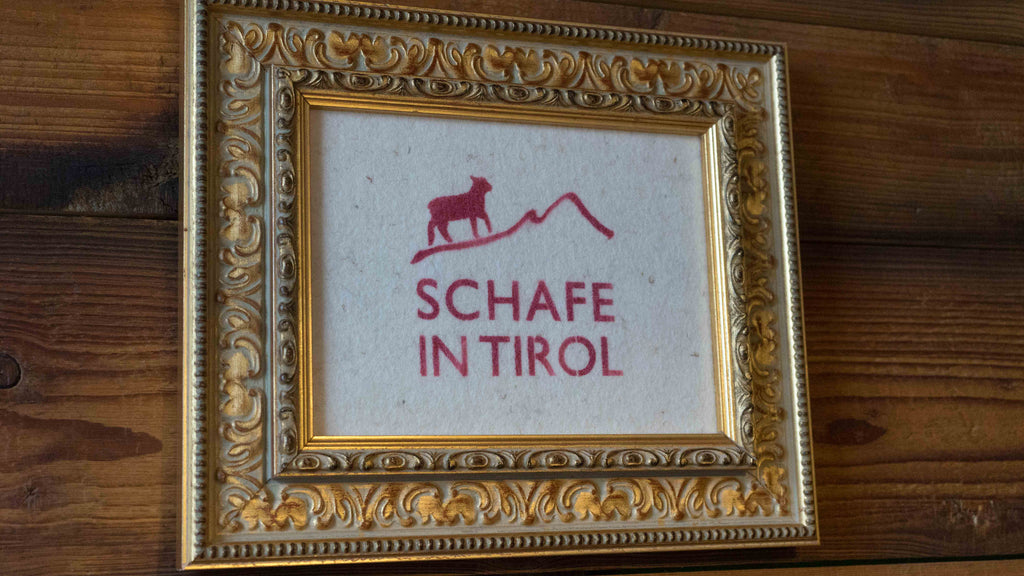 sign that says, "sheep in Tirol" in german