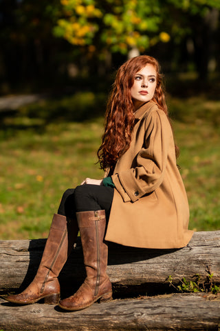 young woman wearing Robert W. Stolz Loden Coat with horseback riding boots