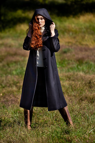 young lady standing in pasture wearing Robert W. Stolz hooded wool coat