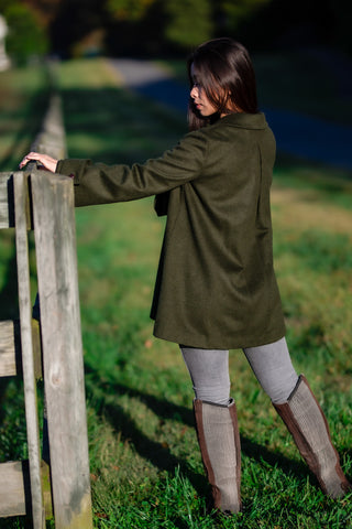 young woman wearing loden green Robert W. Stolz loden coat at horse farm in Maryland