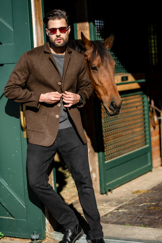 young man wearing Robert W. Stolz loden blazer at luxury stables