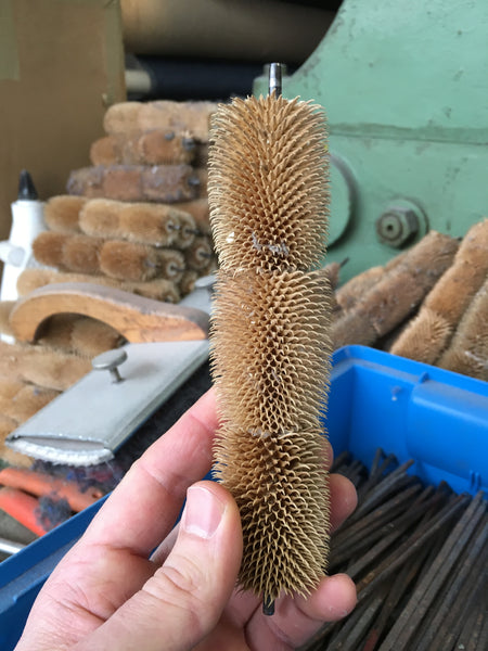 thistle cones on a spindle for brushing loden wool fabric