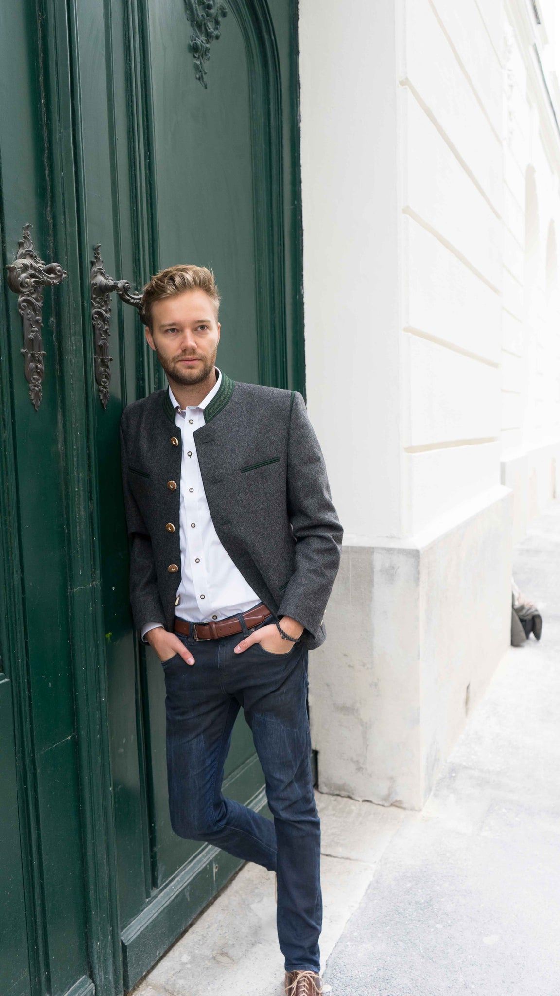 October 8th Photo shoot for Robert W. Stolz in Vienna, Austria featuring model Yannick in a loden jacket standing in front of a green door