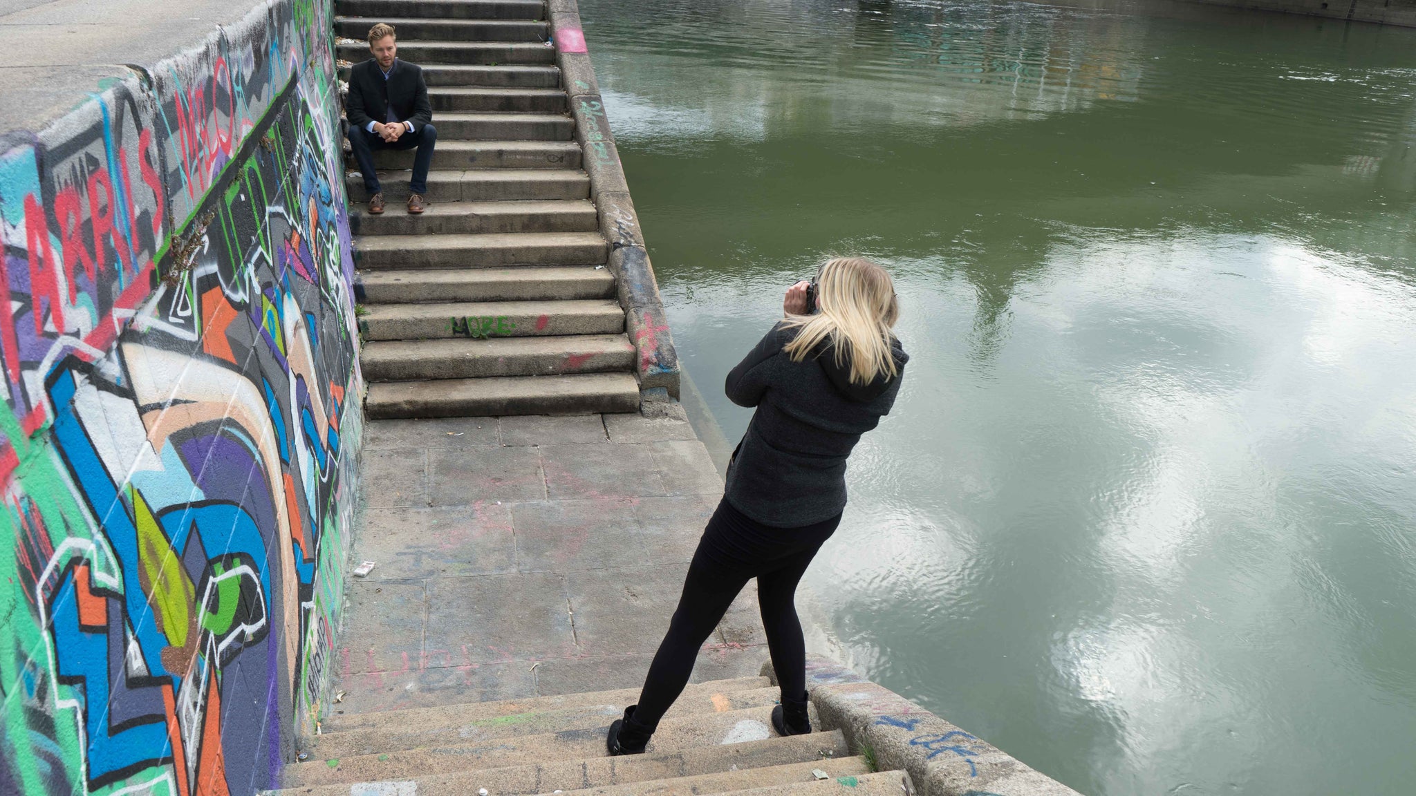 Photo of photographer Astrid Schweyer photographing Yannick in Old Vienna next to the Donal Canal wearing a Robert W. Stolz loden jacket on October 8, 2016