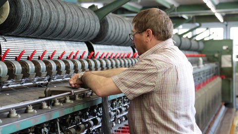 close up of man working on spinning machine