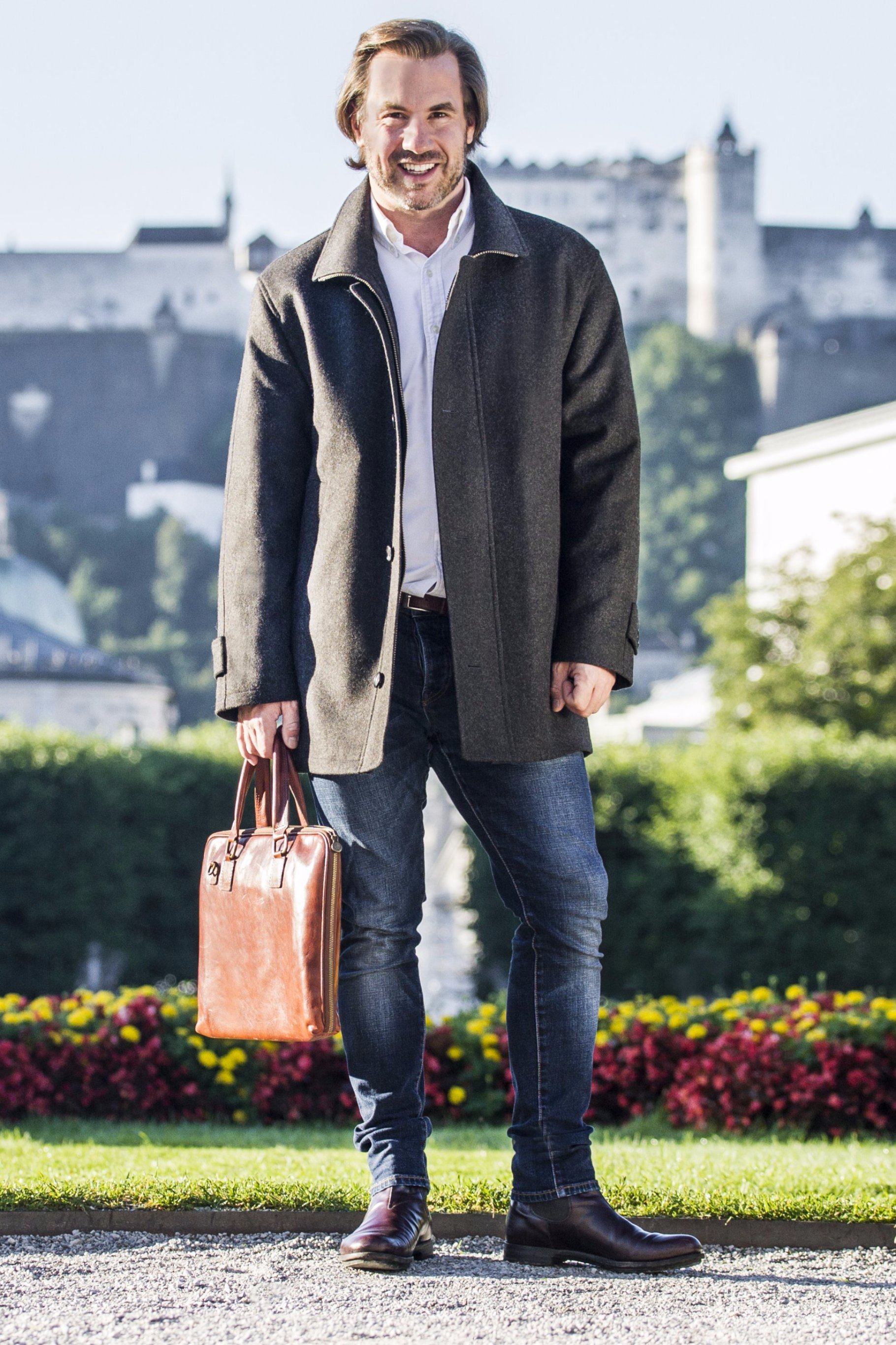 https://cdn.shopify.com/s/files/1/1187/2436/products/man_wearing_Robert_W._Stolz_loden_wool_cruiser_jacket_in_mirabella_park_salzburg_with_castle_in_background.jpg?v=1569026021