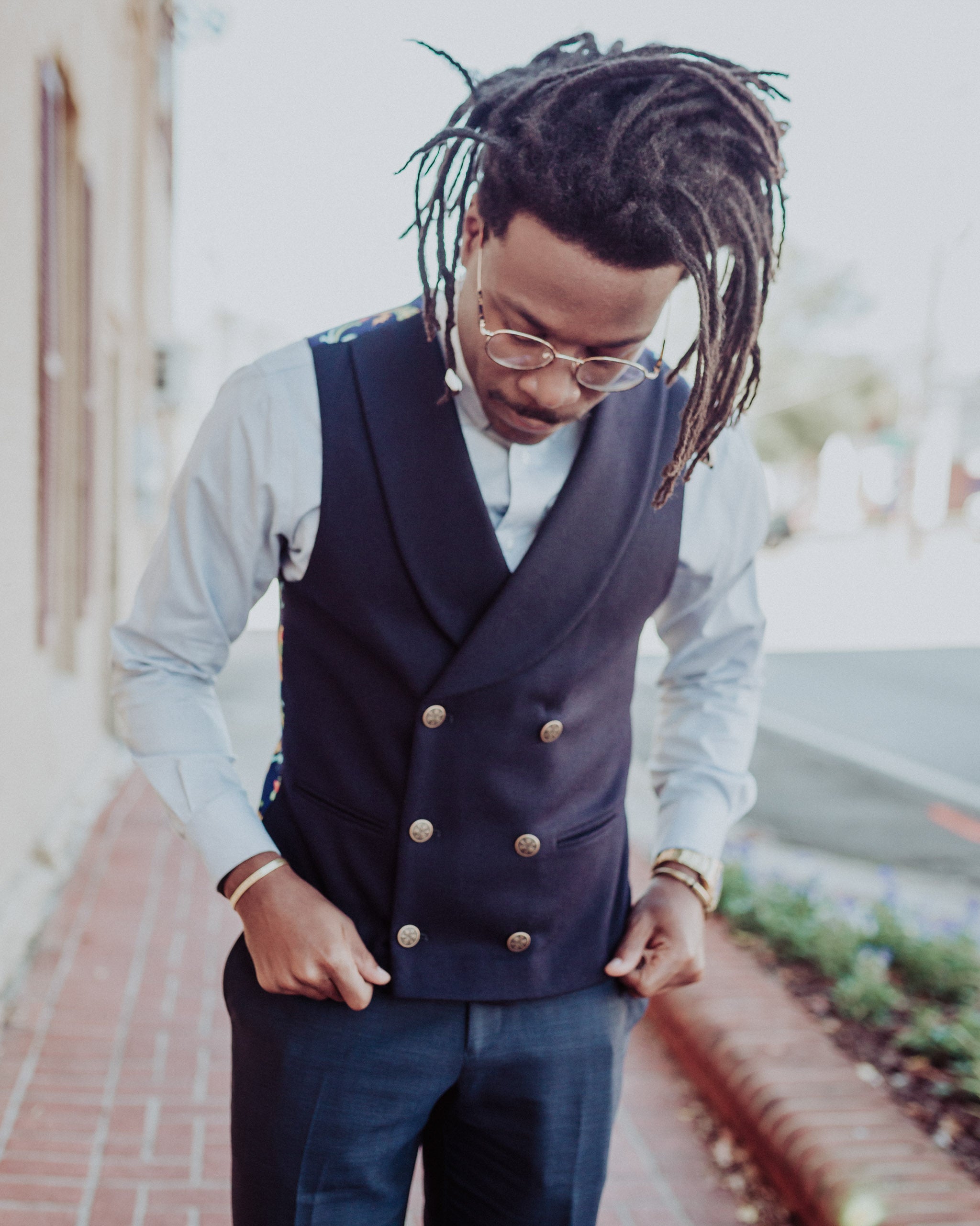 man modeling in a navy blue wool front double breasted shawl collar men's vest