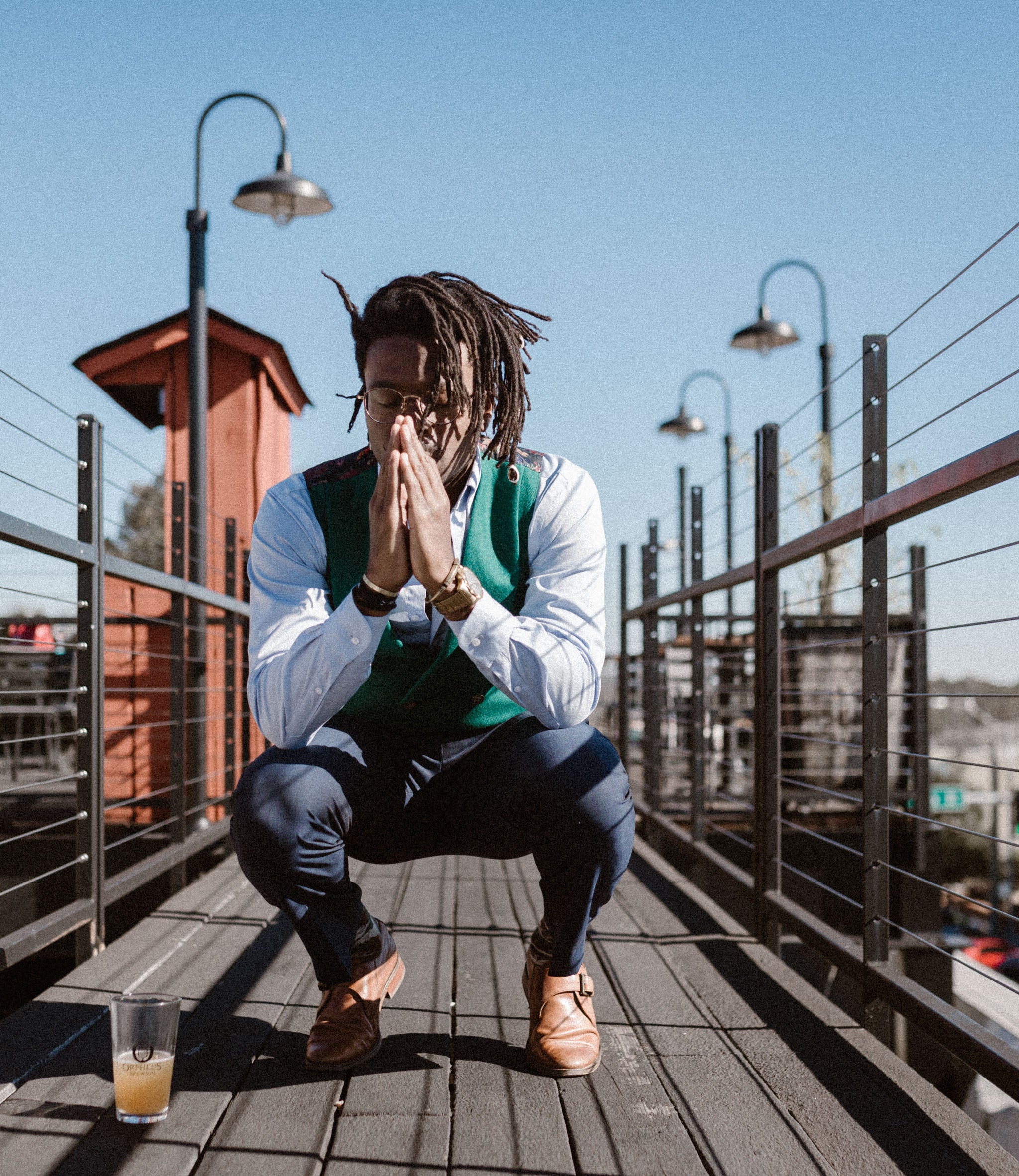 man praying in a green wool front double breasted shawl collar men's vest