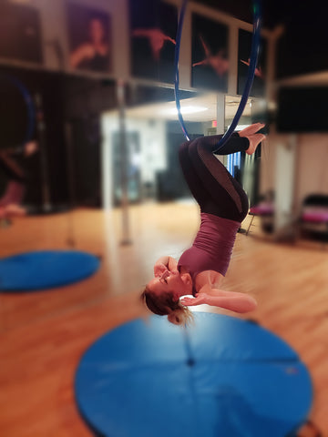 Girl doing an Inverted Sit Up on her Aerial Hoop