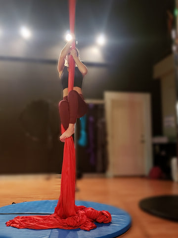 Girl Trying to Climb her Red Aerial Silks