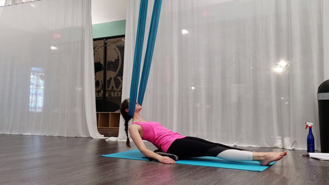 Girl doing a Neck hang in our Aerial Hammock