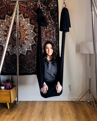 Girl sitting on her Black Aerial Hammock