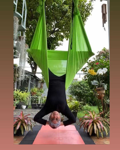 Girl doing an inversion on her Green Aerial Hammock