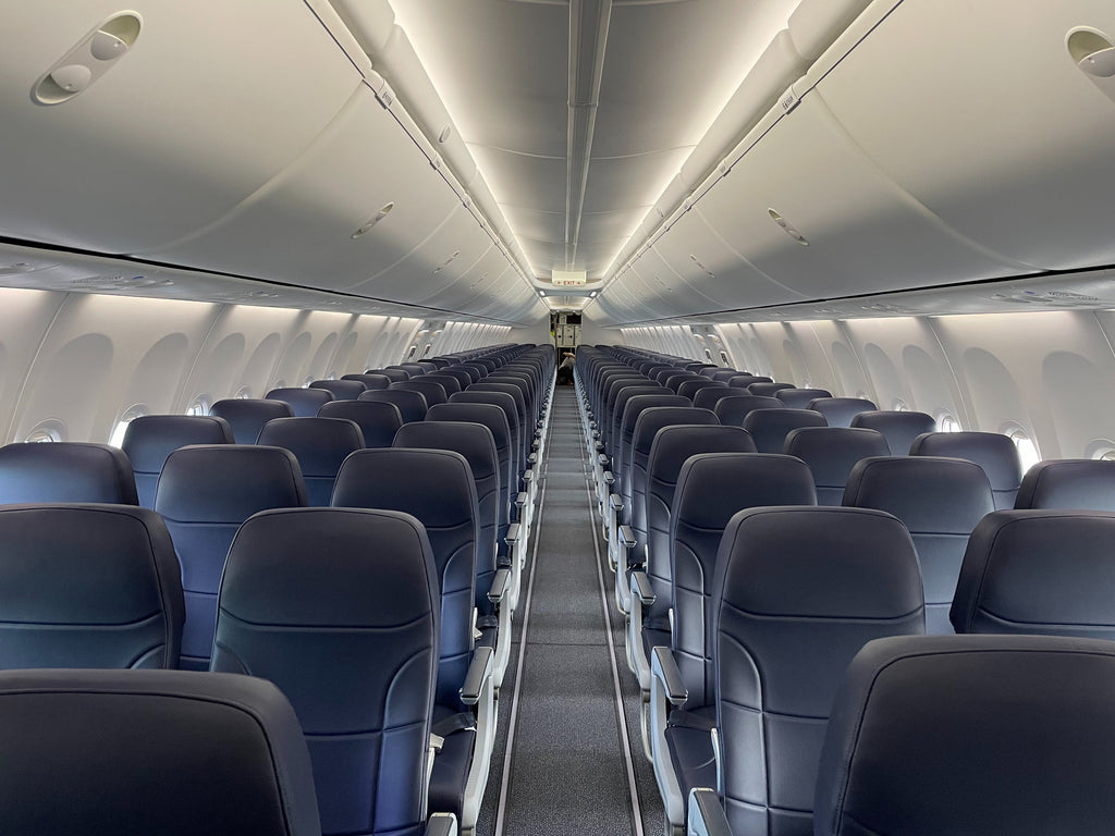 Seats on an airplane. Photo by Vitaliy Todo: https://www.pexels.com/photo/empty-blue-airplane-seats-13078165/