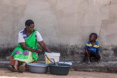 Anna separating the Marula fruit, from the peels and the initial juice