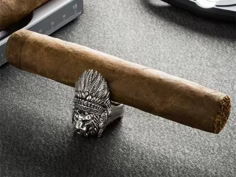 An exquisite silver lion cigar stand with a cigar