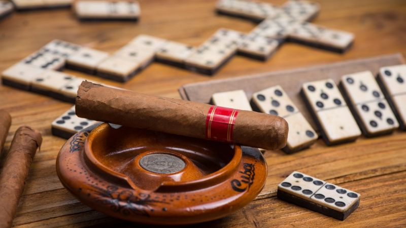 Cuban Cigar on Table with Domino Game