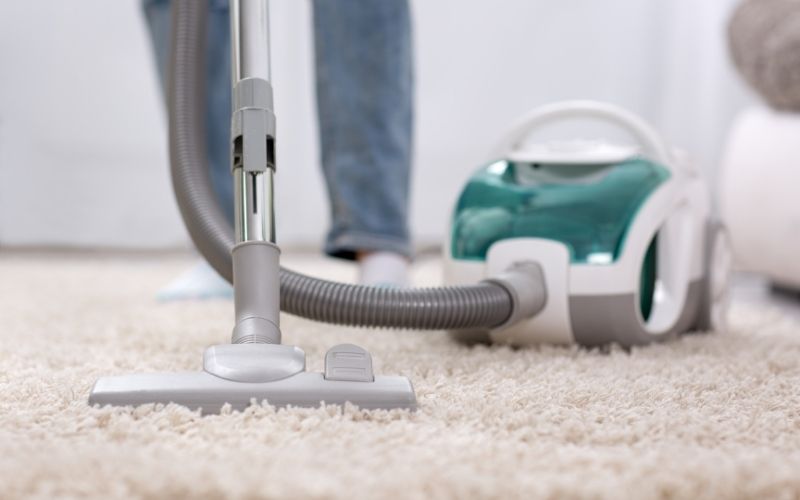 Vacuuming the carpet
