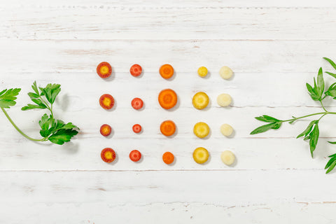 Cut veggies on white wood background