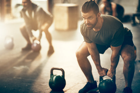 man with kettlebell exercises