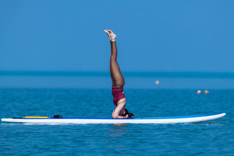 extreme balancing woman on surfboard