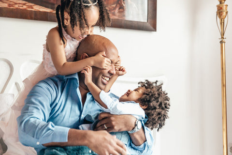 Father with son and daughter playing