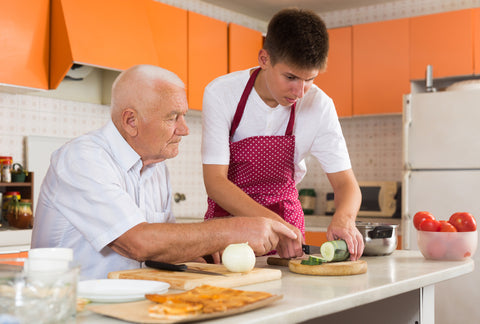 grandpa teaches grandson to cook