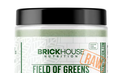 Container of BrickHouse Nutrition Field of Greens supplement with 'Raw' label.