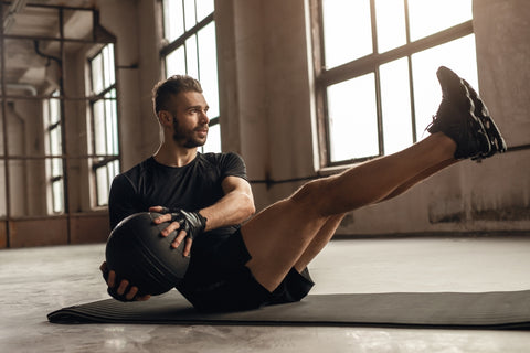 man doing medicine ball twist